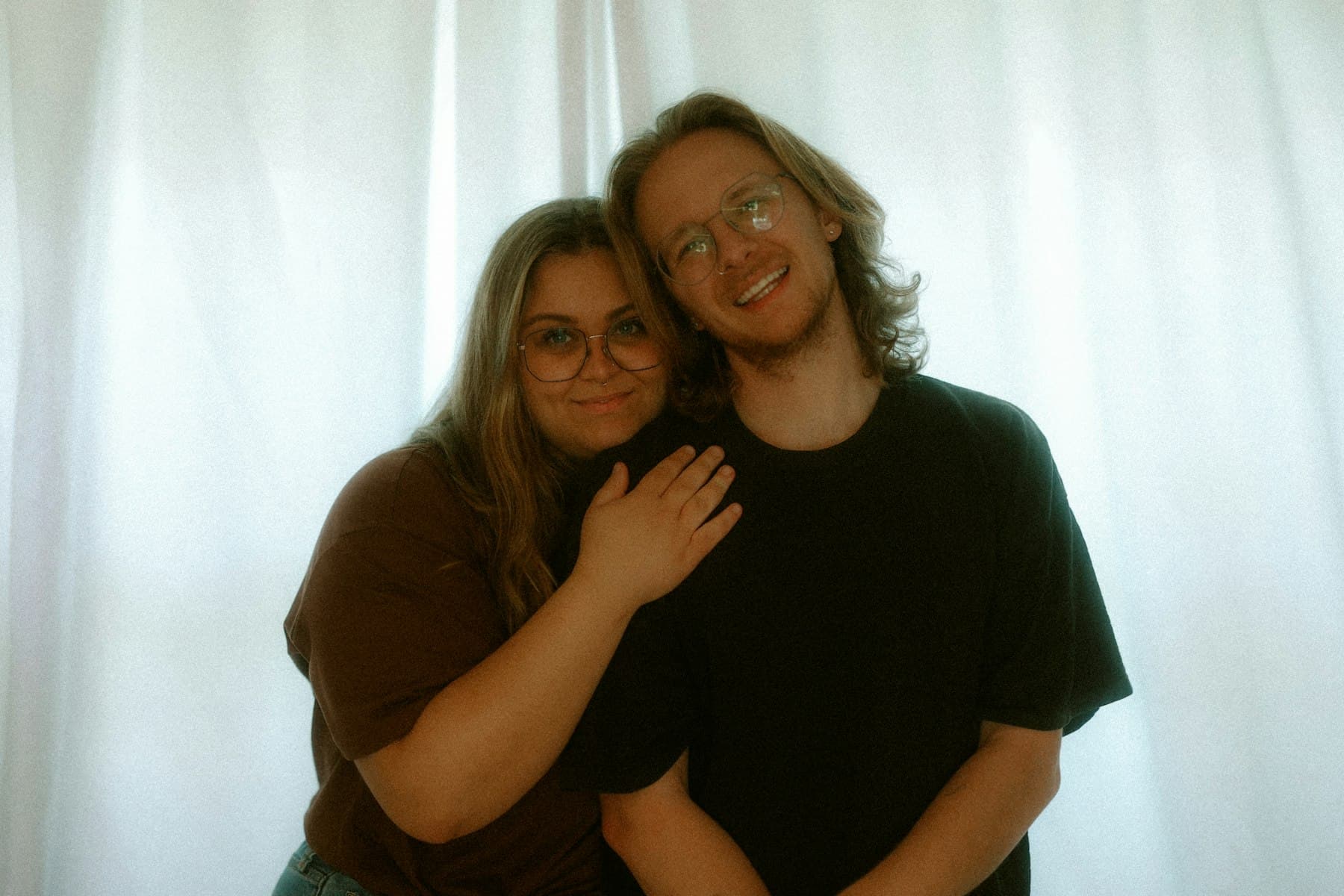 Two people smiling indoors